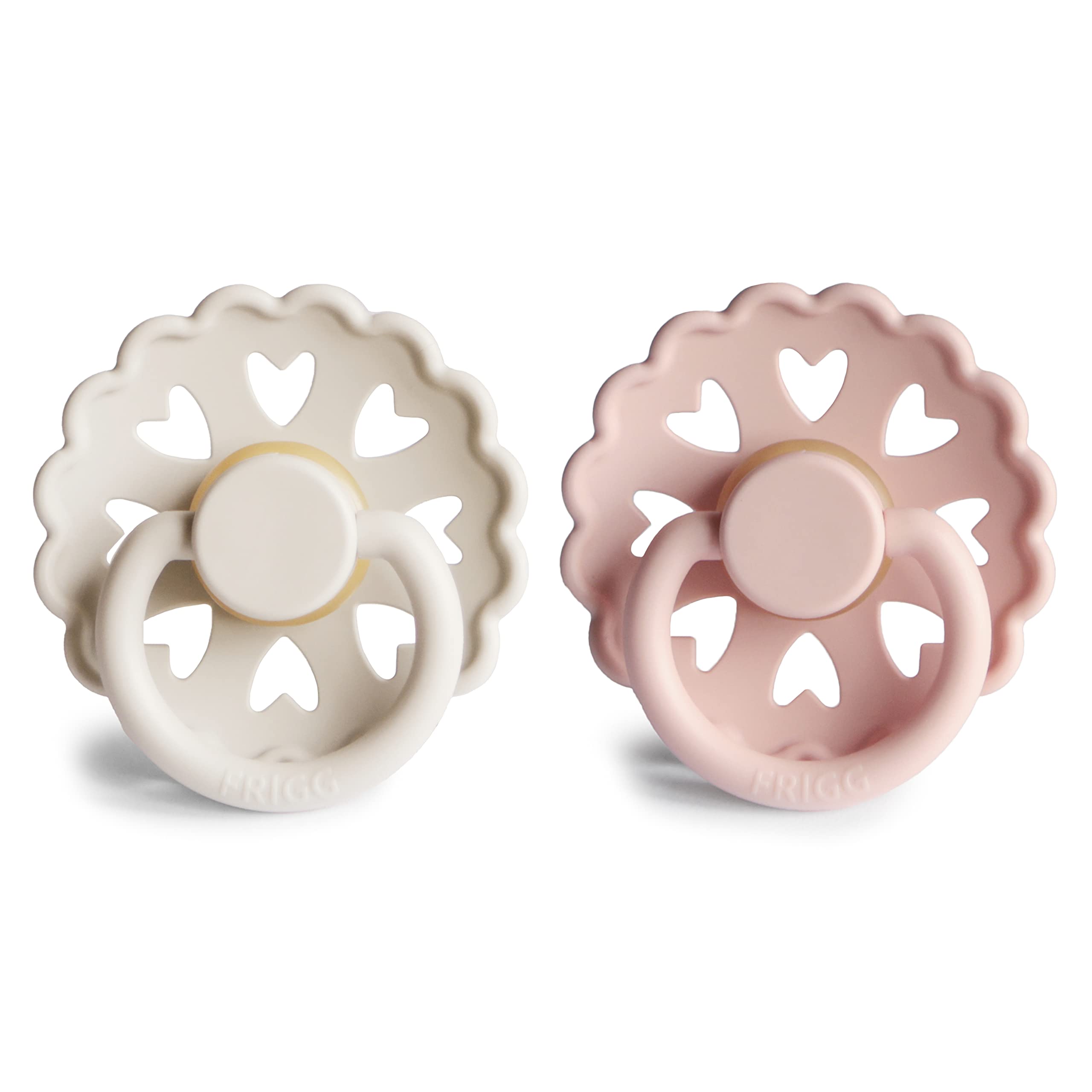 FRIGG Andersen Fairytale pacifier cream-blush held by mom for easy soothing during feeds.