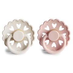 FRIGG Andersen Fairytale pacifier cream-blush held by mom for easy soothing during feeds.