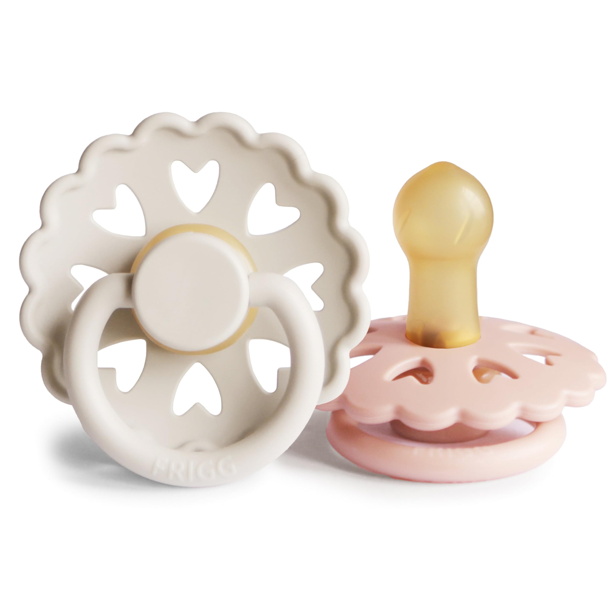 FRIGG Andersen Fairytale pacifier in cream-blush gently rests against a soft blanket for calming newborn moments.