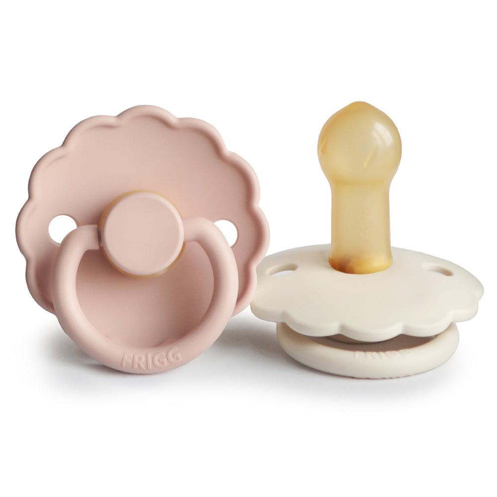 FRIGG Daisy blush-cream pacifier pack view shows two BPA-free natural rubber pacifiers for soothing comfort.