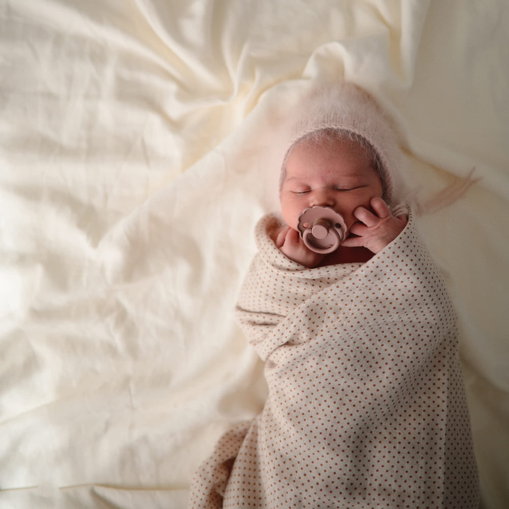 FRIGG Daisy SilkySoft pacifier security handle helps keep the pacifier nearby