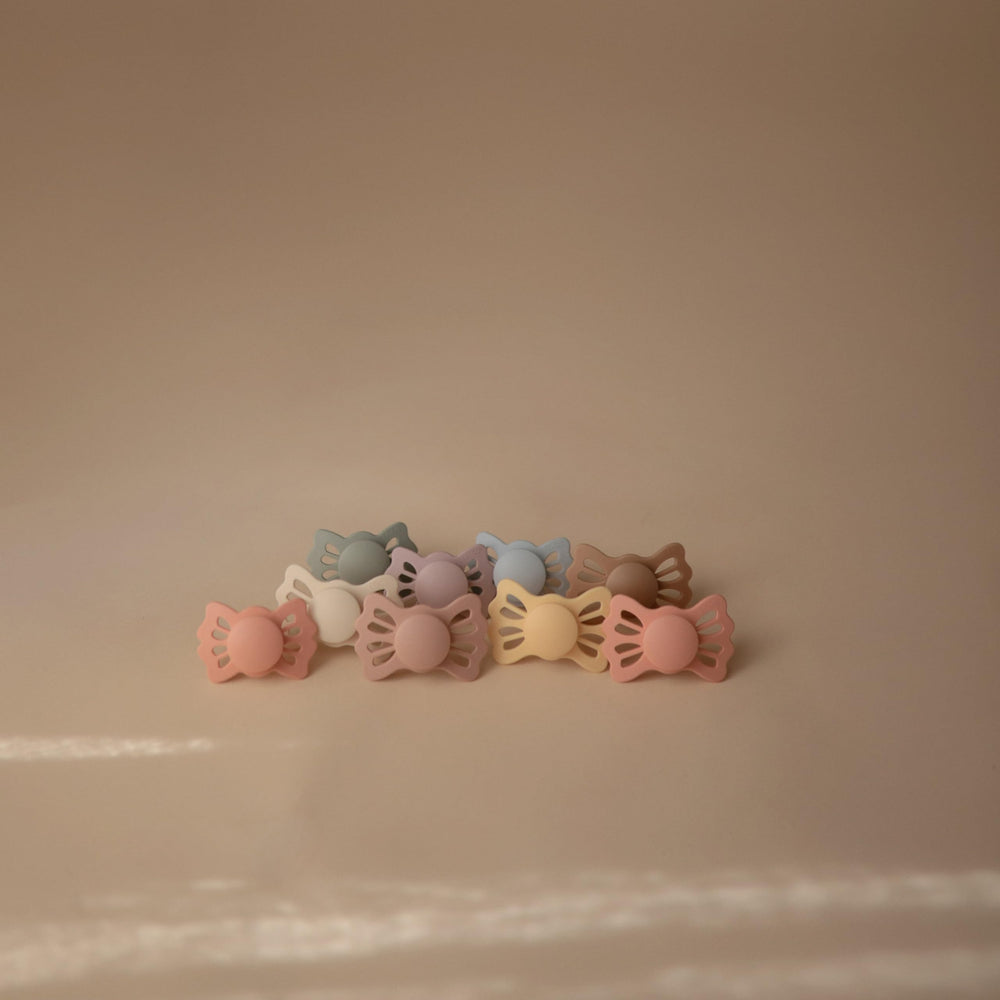 Frigg Lucky sage-gray pacifier in packaging close-up for color coordination