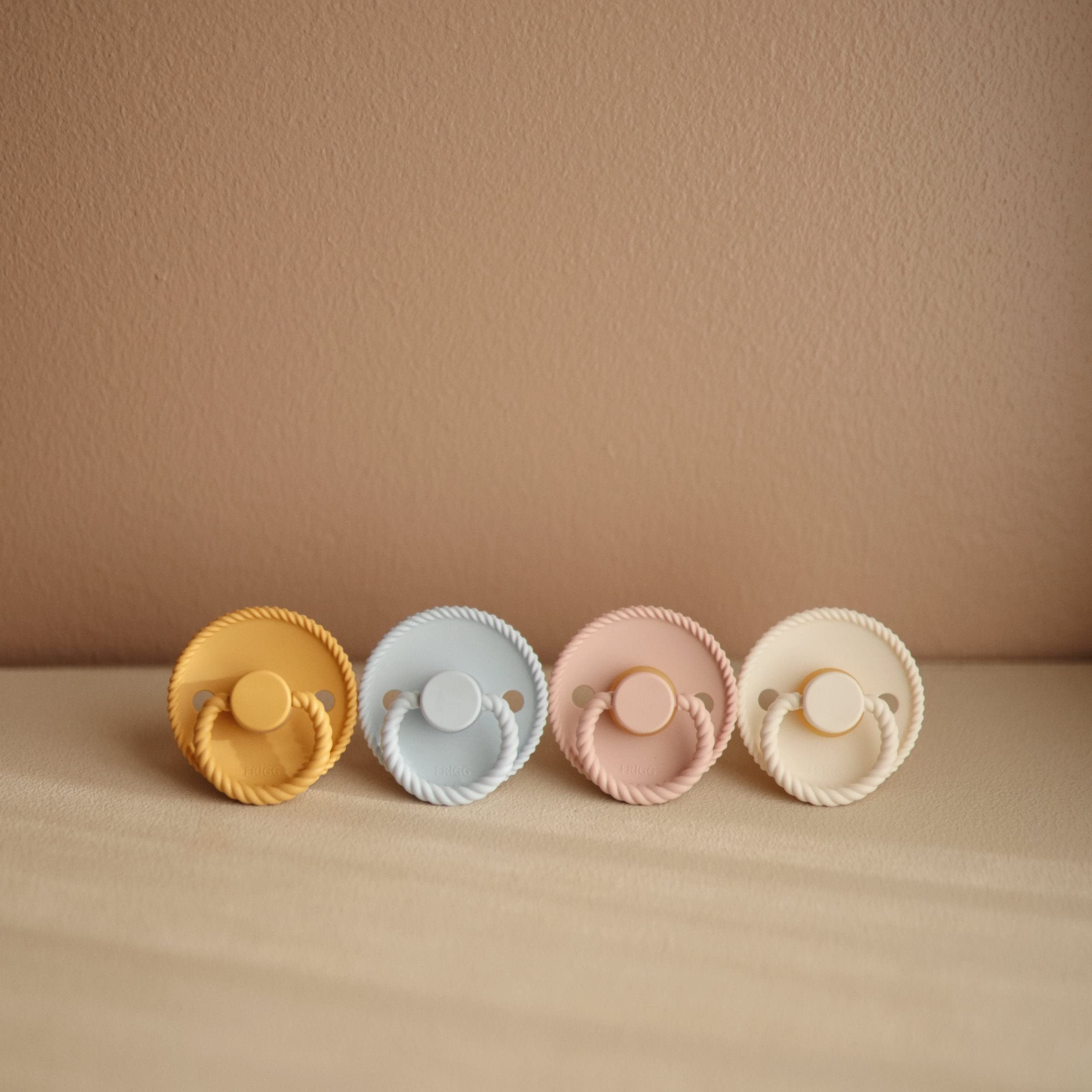 Frigg rope natural rubber pacifier in Croissant color shows calming design and ergonomic appeal
