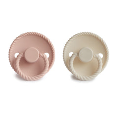 FRIGG Rope SilkySoft pacifier in hand showing ergonomic design for comfort