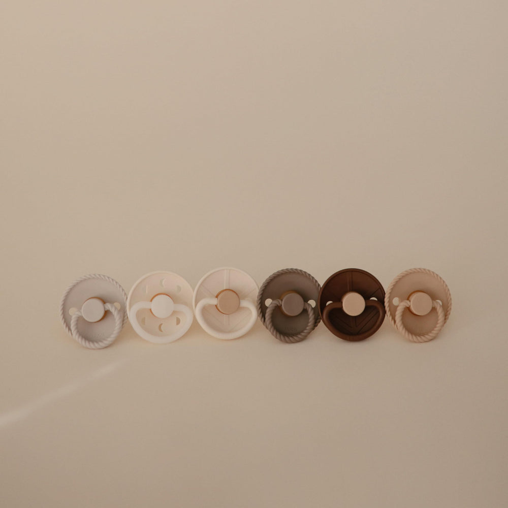FRIGG SilkySoft pacifier outward-curve design keeps nipple off baby's skin for comfort.