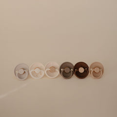 FRIGG SilkySoft pacifier outward-curve design keeps nipple off baby's skin for comfort.