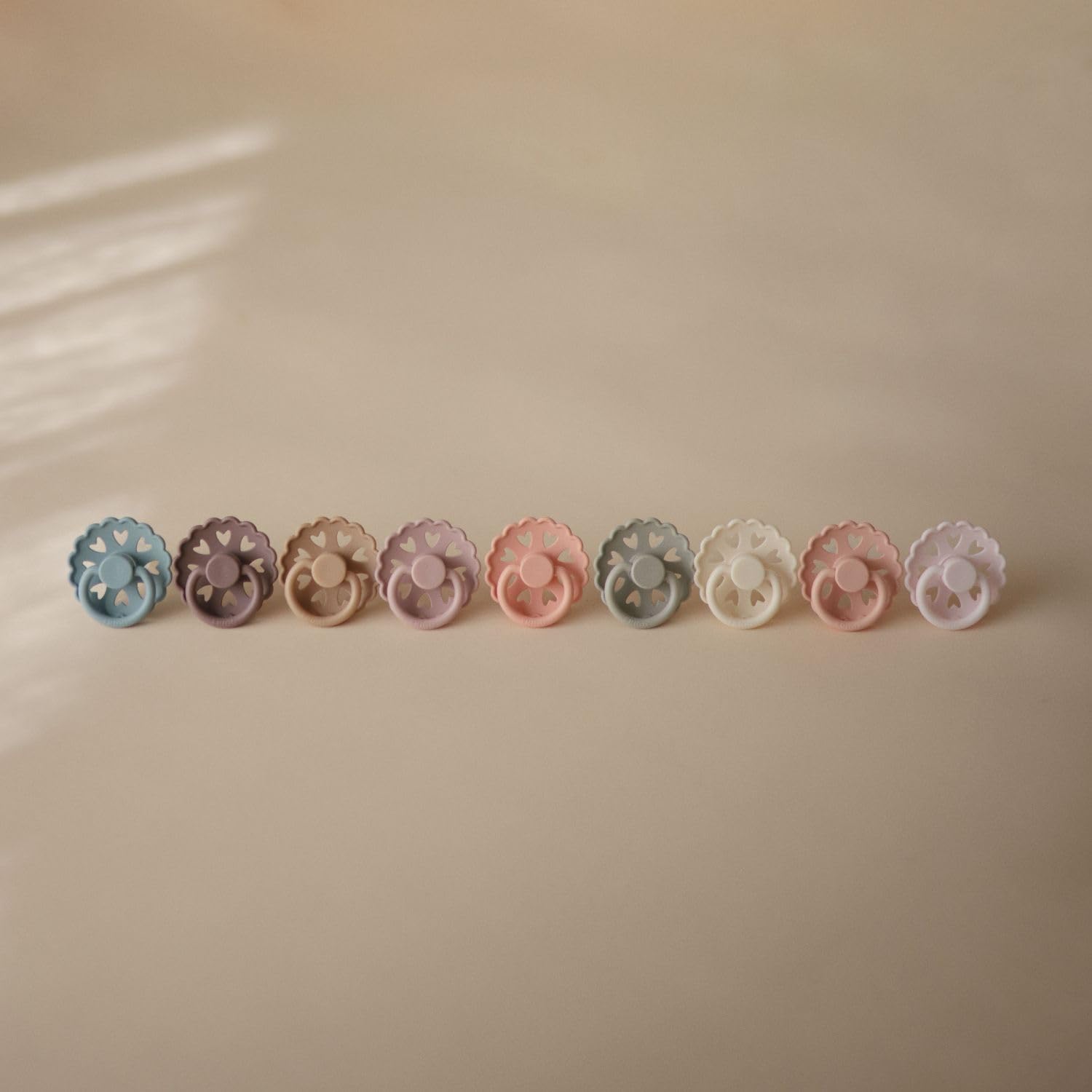 FRIGG SilkySoft pacifier soft colors coordinate with outfits.