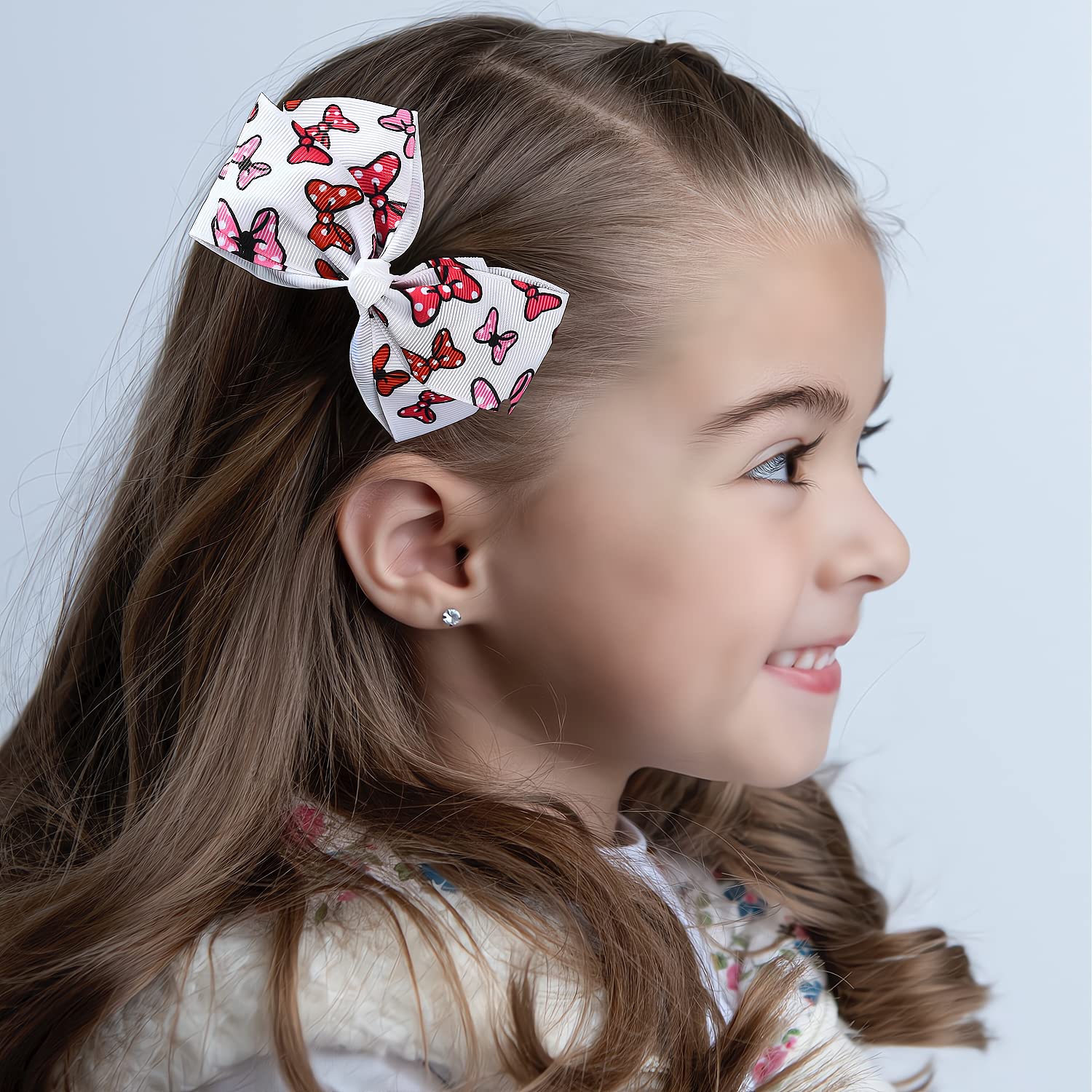 Fsmiling party-ready bow clips add color and charm to festive outfits.