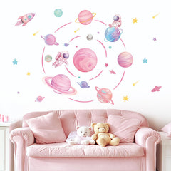 FUFUQUARE pastel pink planet orbits wall decal with rocket sparks imaginative play in kids room.