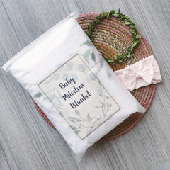 Fundich milestone blanket with wreath marker, helps showcase monthly growth in photos.