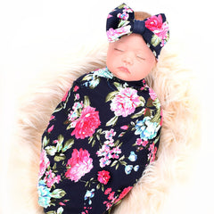Galabloomer headband coordinating with navy rose print for stylish, comfy baby wear.