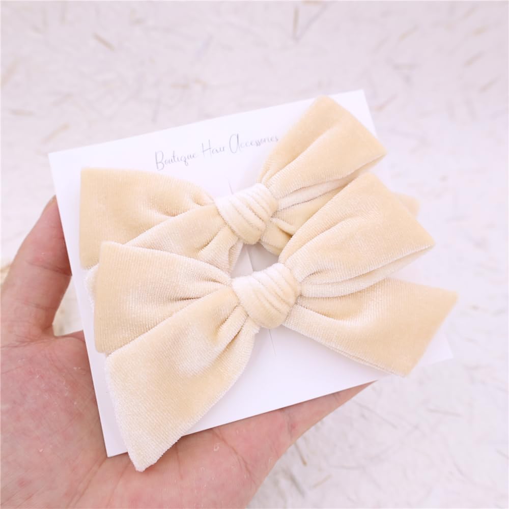Gebelle cream velvet bow on child — festive holiday styling.