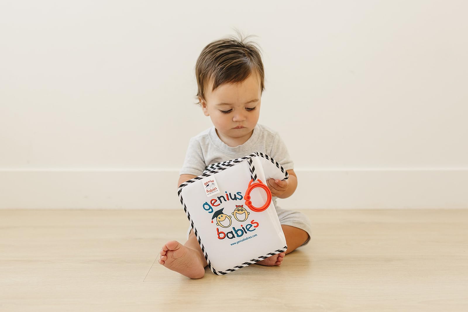 Genius Baby Toys baby photo album featuring soft edges for safe exploration.