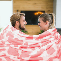 GEULAY pink cow print throw on couch for warmth and protection