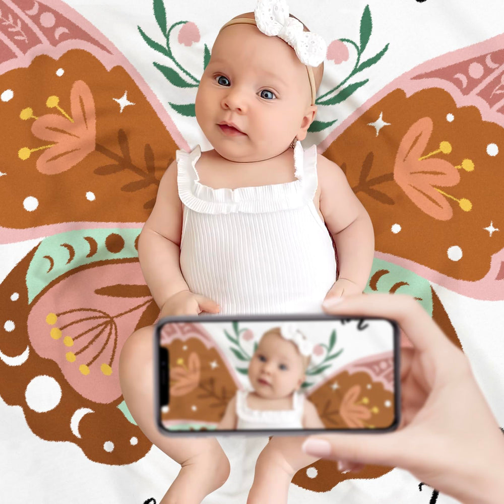 Gicoherero baby photo prop setup with blanket and decorations.
