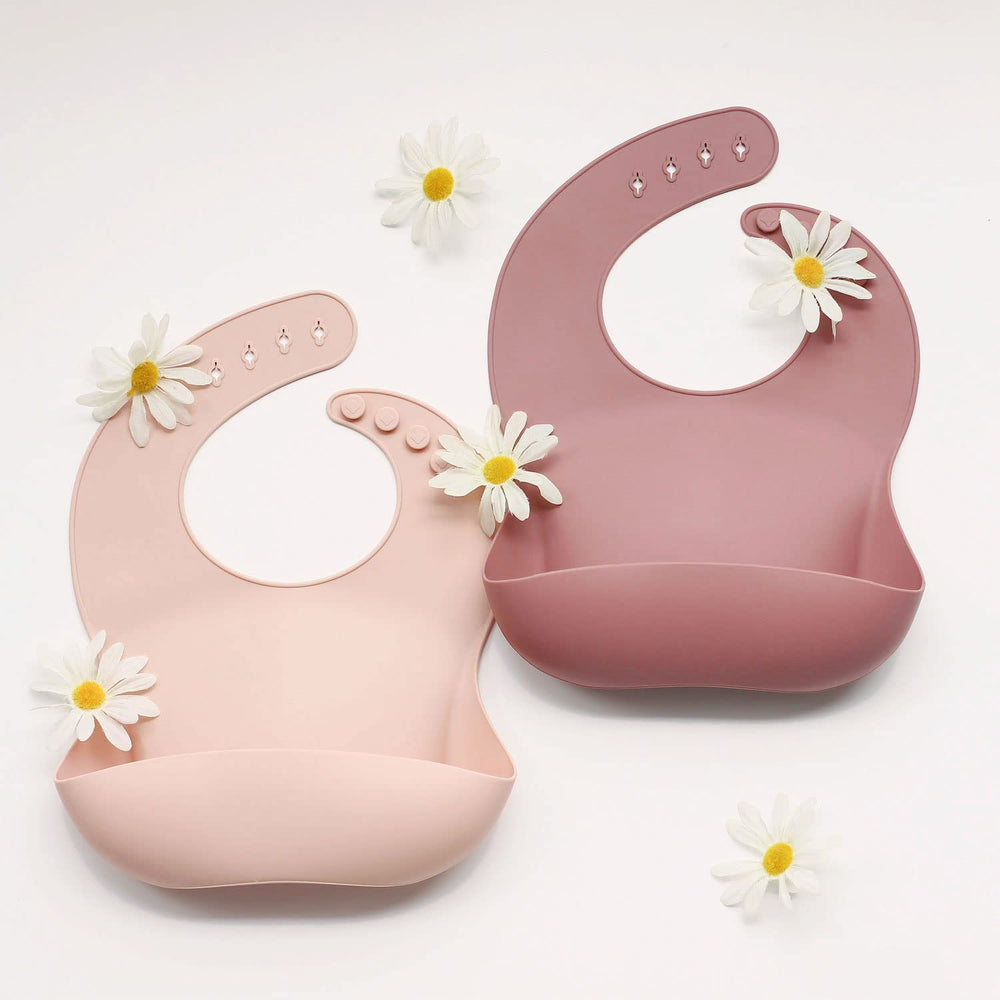 Ginbear silicone bib mauve-pink food-catcher pocket helps keep outfits clean during meals.