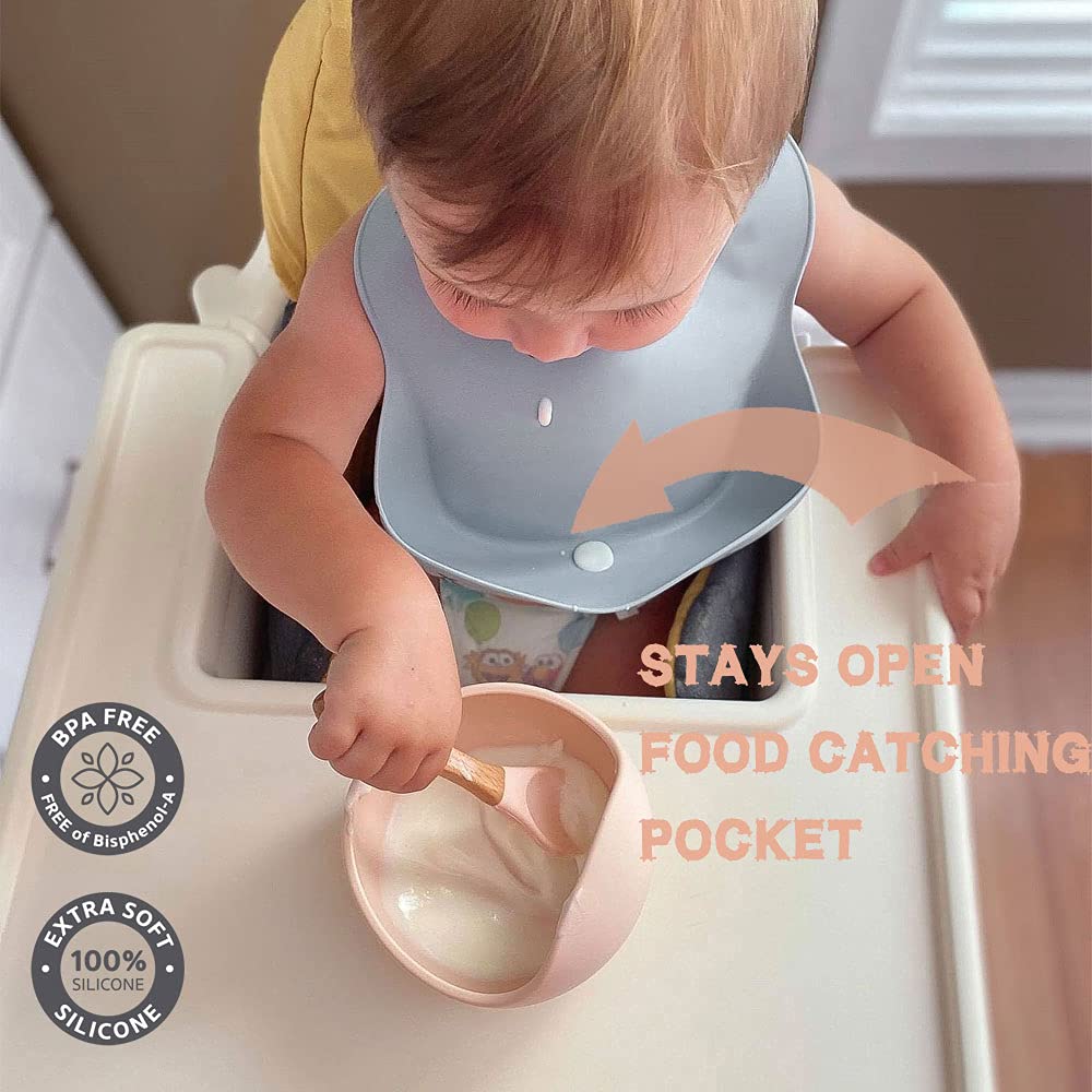 Ginbear silicone bib with secure shoulder strap closure reduces bib slipping during self-feeding.