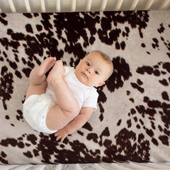 Glenna Jean Brown Cow crib sheet on mattress—snug, gentle fit.