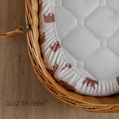 GLLQUEN BABY bassinet sheets in nursery decor scene with gentle floral backdrop.