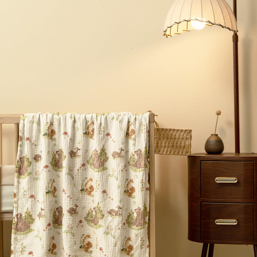 GLLQUEN BABY Forest Stories blanket on changing pad demonstrates versatile baby care use