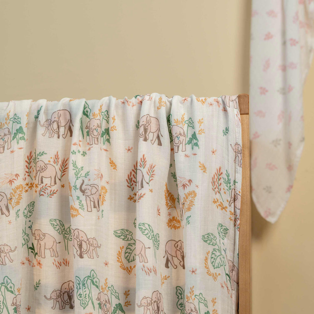 GLLQUEN BABY muslin swaddle blanket in nursery scene shows versatility