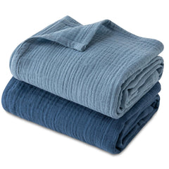 GLLQUEN BABY muslin swaddle blanket close-up shows soft breathable cotton for baby comfort.