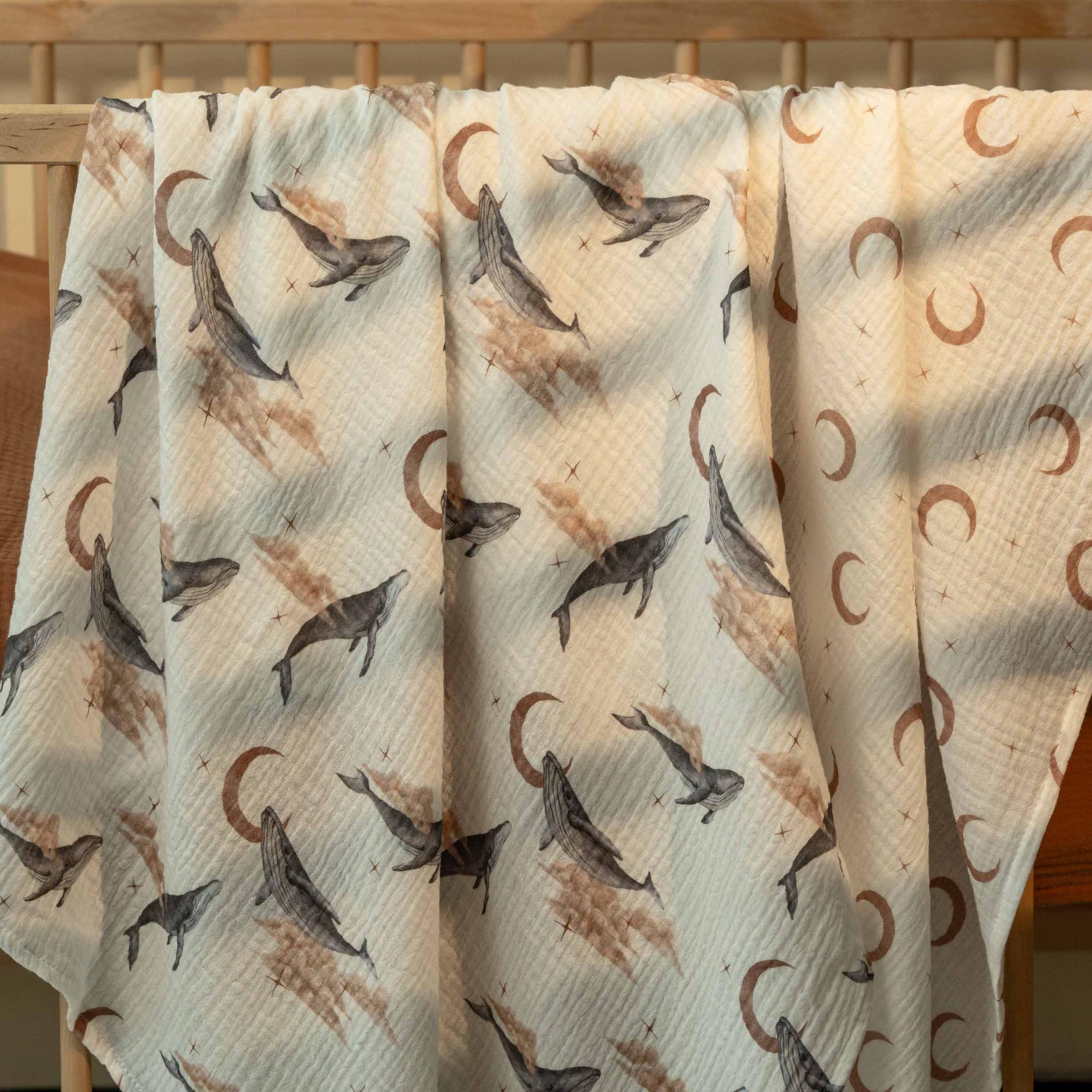 GLLQUEN BABY swaddle blanket in use to wrap a sleeping baby for calm soothing.