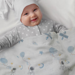 GLLQUEN BABY muslin swaddle blue astronaut opened for quick wraps during naps.