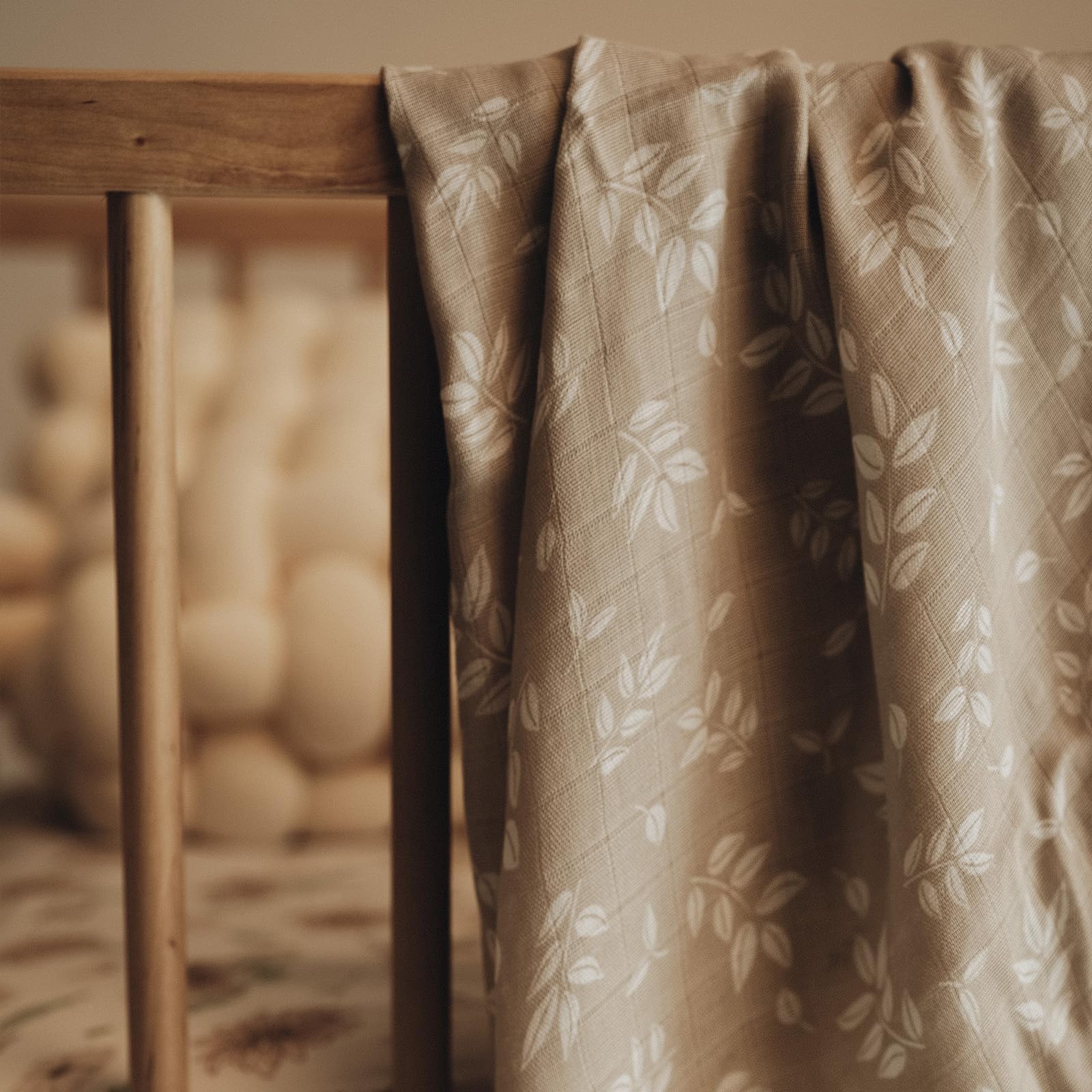 GLLQUEN BABY muslin swaddle multiuse blanket shows versatile use as burp cloth or cover.