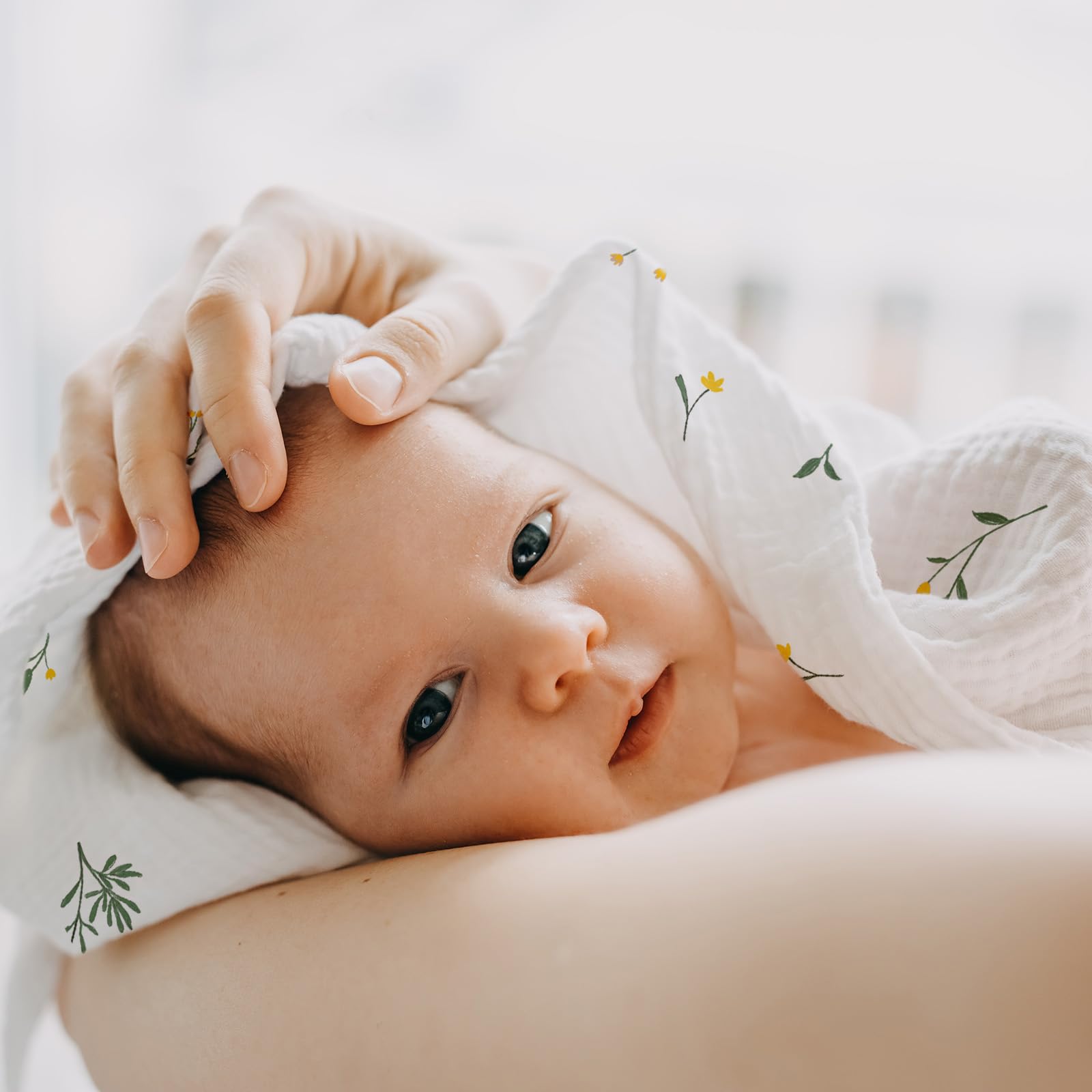 GLLQUEN BABY muslin swaddle neutral colors laid out for unisex baby outfits