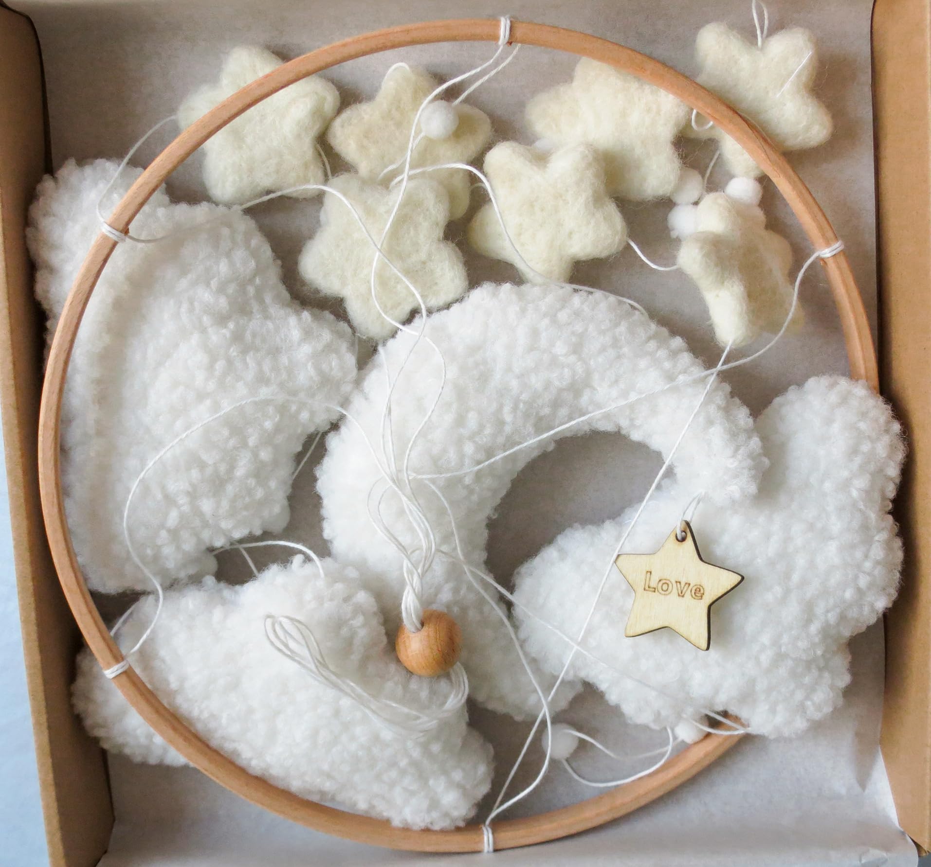 Goukurlsma boho crib mobile with stars for visual exploration in a neutral nursery.