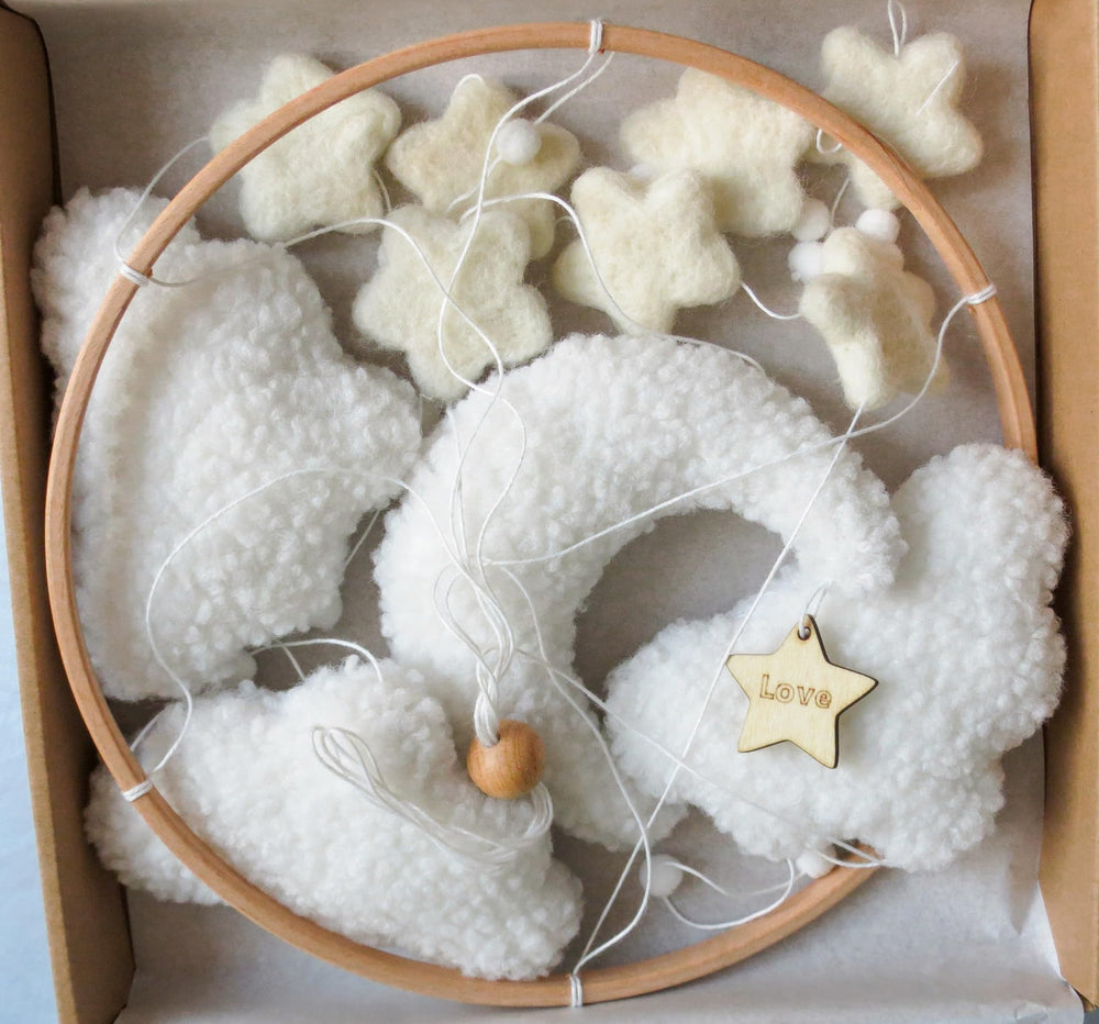 Goukurlsma boho crib mobile with stars for visual exploration in a neutral nursery.