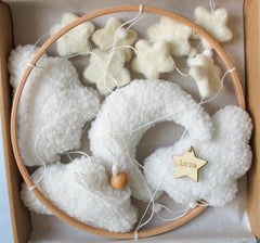 Goukurlsma boho crib mobile with stars for visual exploration in a neutral nursery.