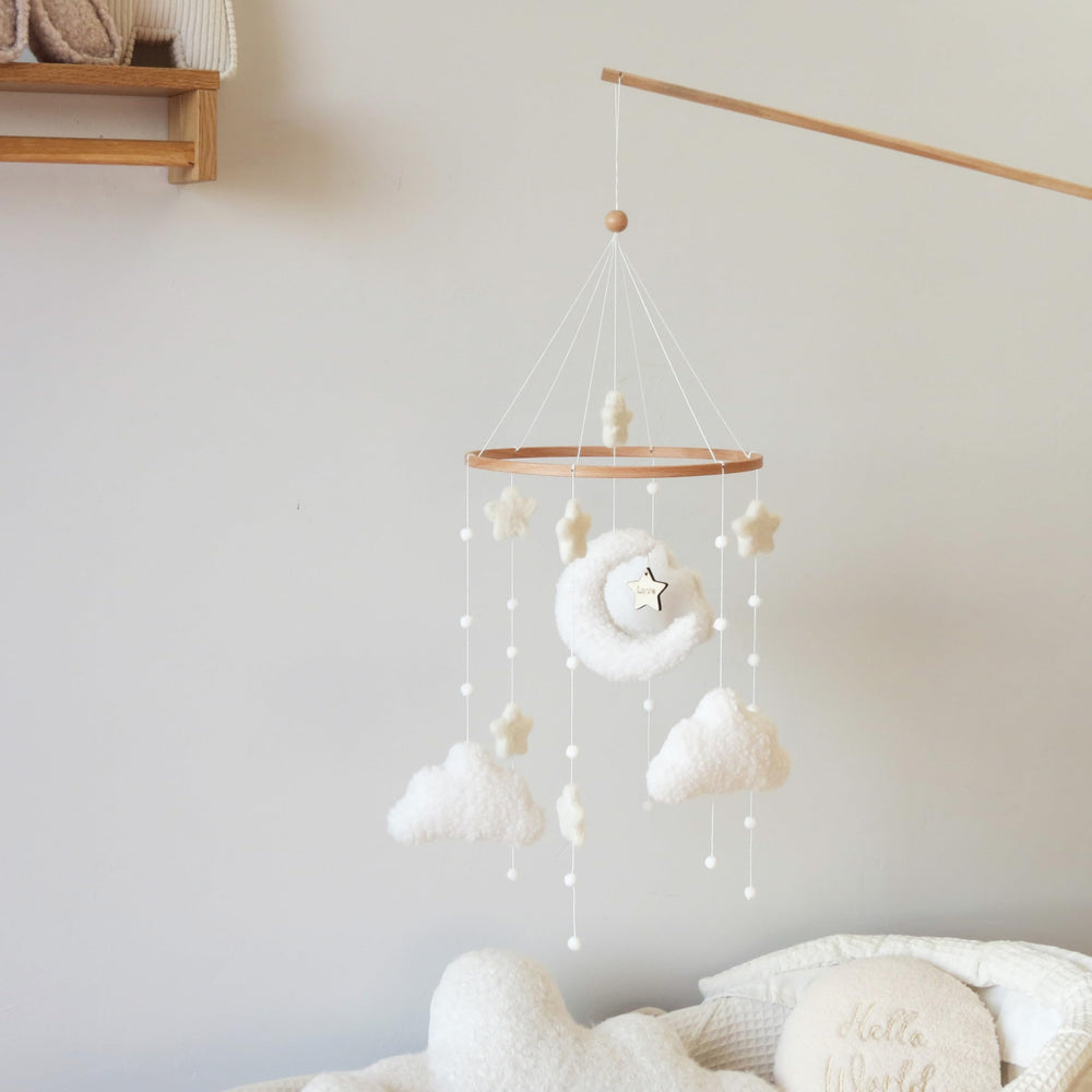 Goukurlsma boucle cloud fabric accent on mobile adds tactile texture for baby.
