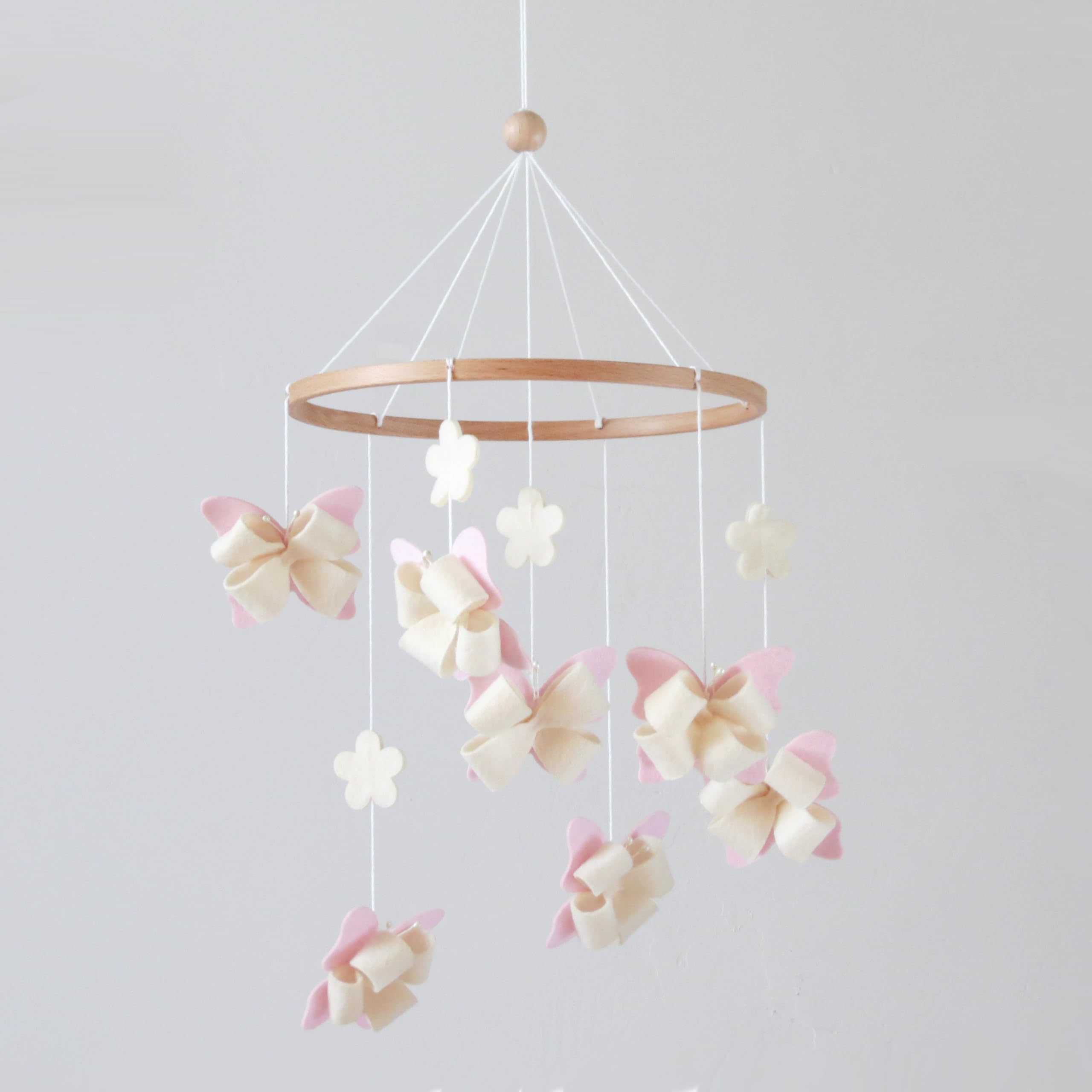 GOUKURLSMA butterfly mobile for crib with seven butterflies and four flowers in a calm nursery scene