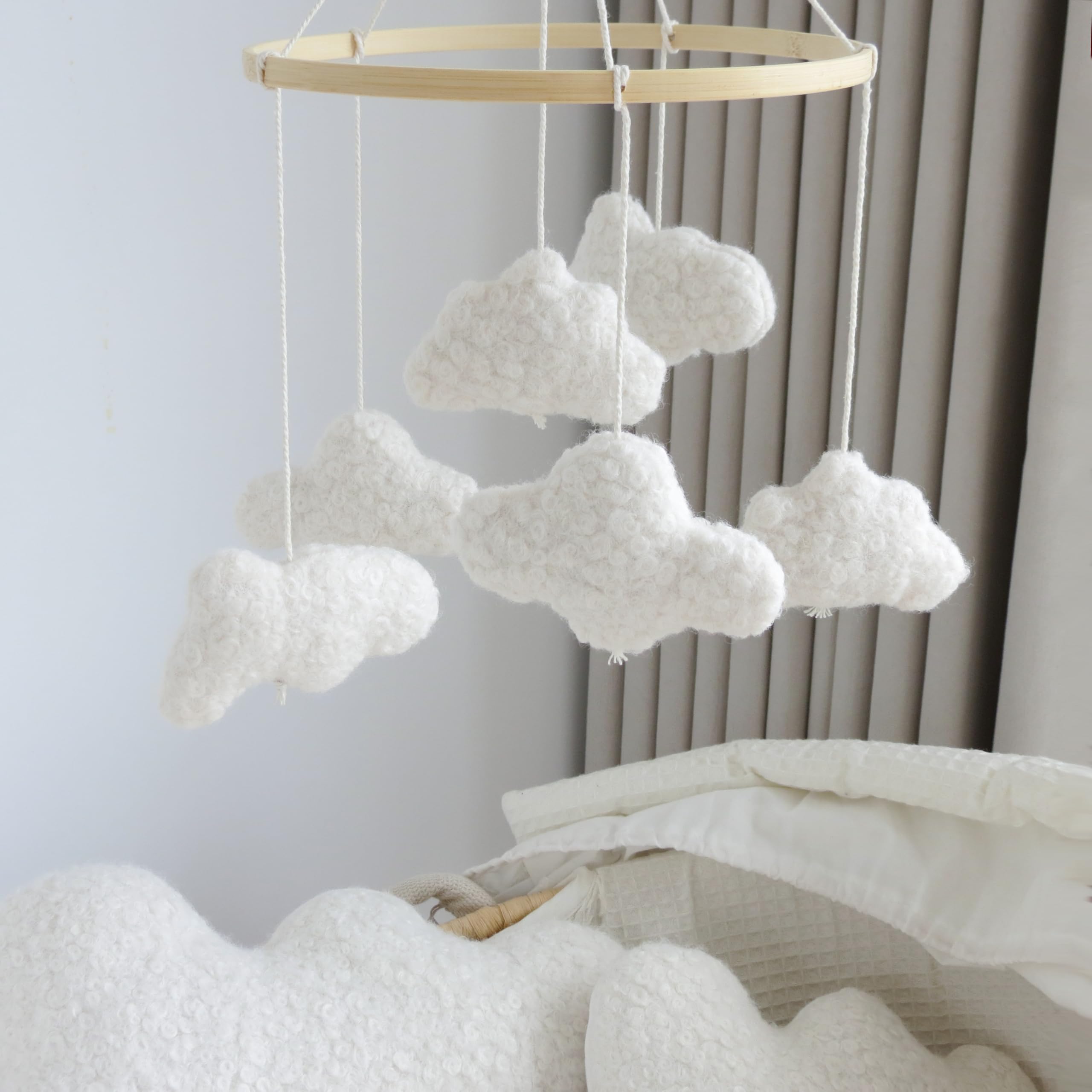 Goukurlsma Cloud Mobile hangs above crib creating a gentle sleep space.
