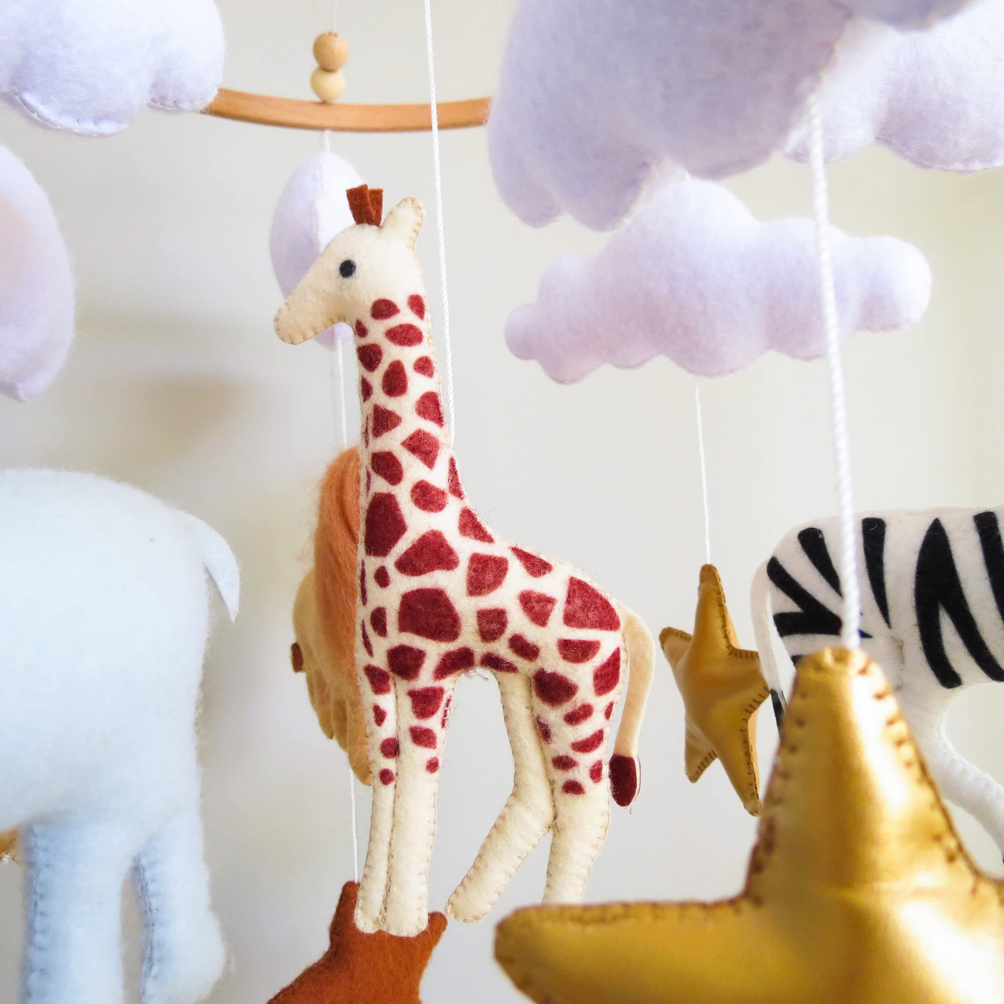 Goukurlsma Jungle Crib Mobile giraffe figure offers gentle motion for soothing stories.