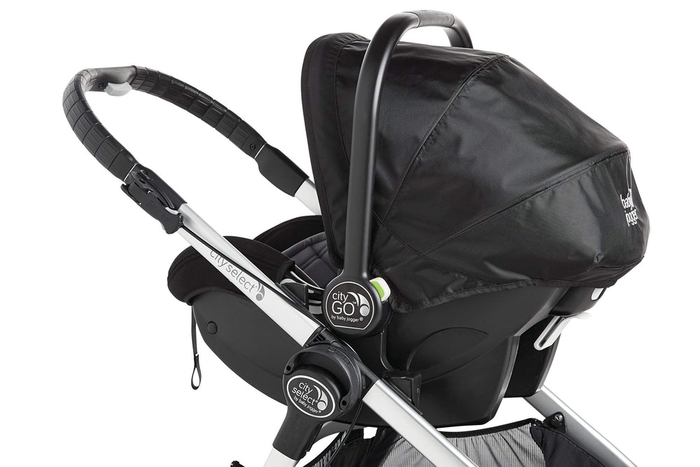 Graco infant seat mounted via Baby Jogger adapter demonstrates portable travel system.