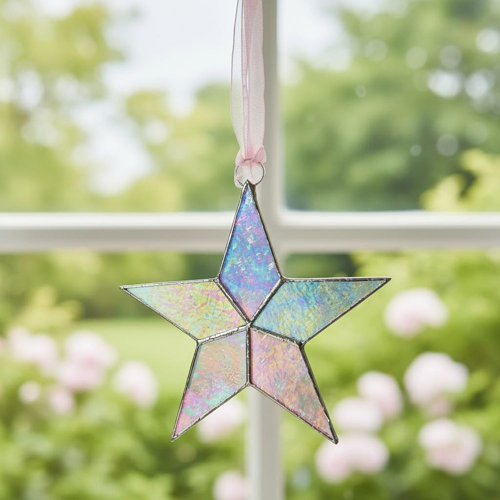 The Grandparent Gift Co pink organza ribbon star ready to hang in a nursery.
