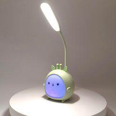 Green Deer LED night light on table delivering soft nursery glow.