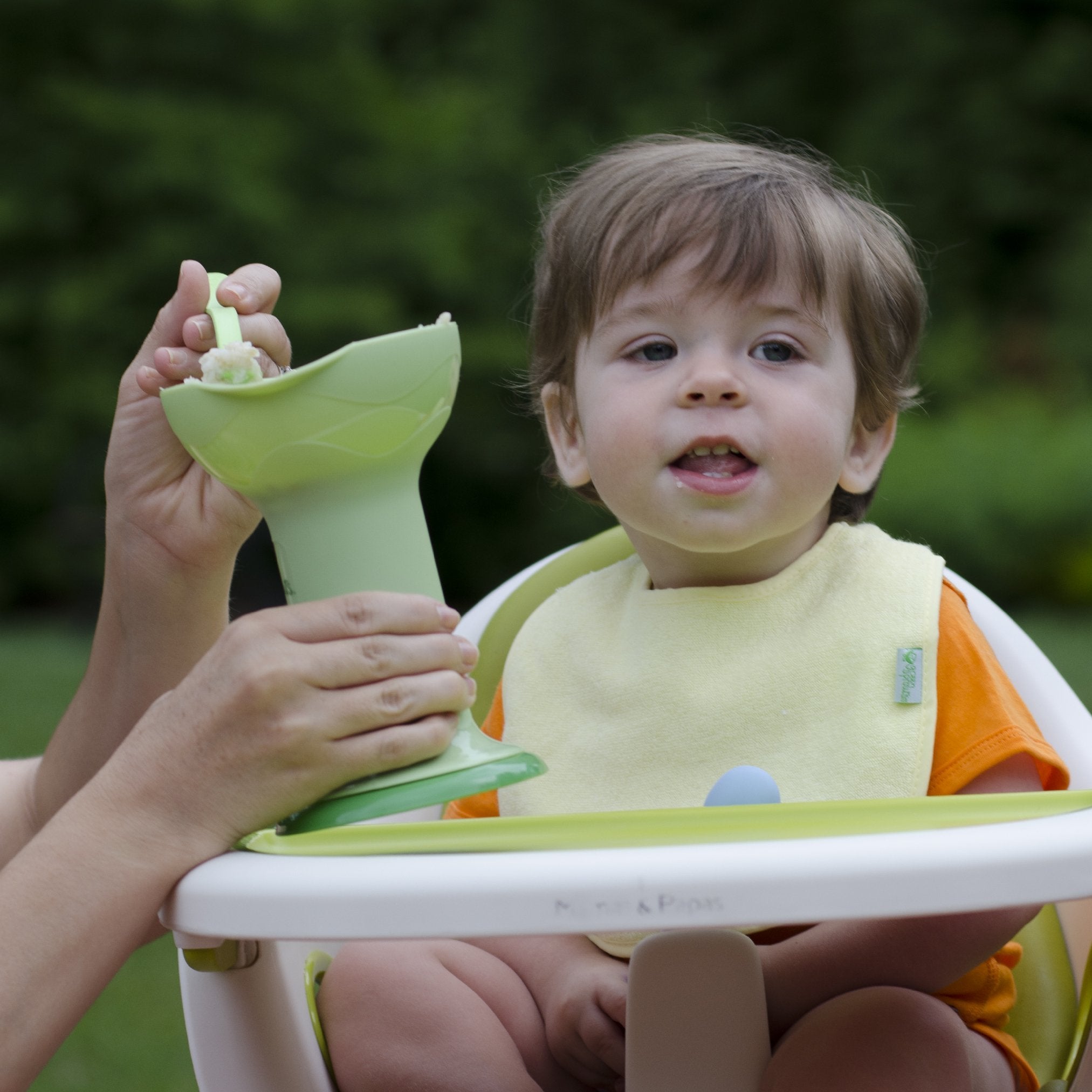 Green Sprouts Fresh Baby Food Mill used on the go for in-car or travel meals.