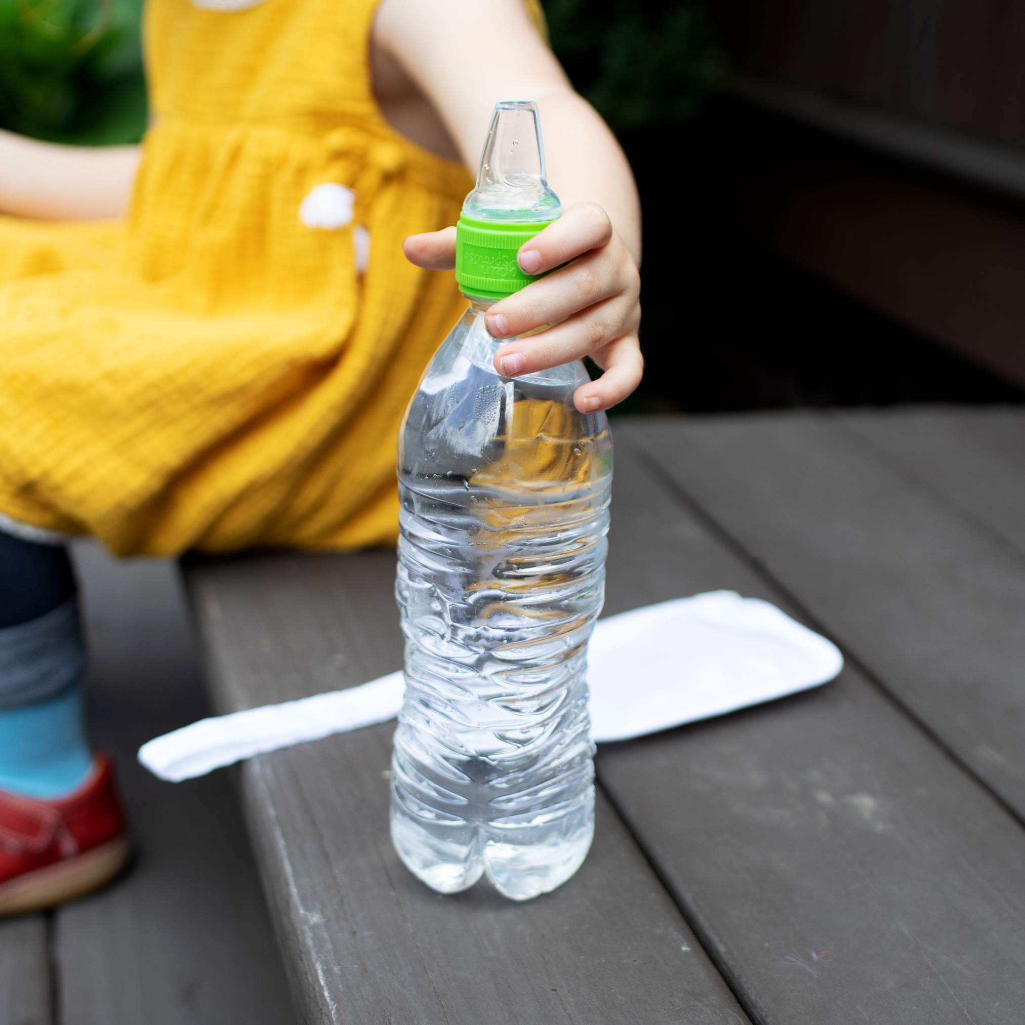 Green Sprouts Spout Adapter in use on a standard bottle for toddler-friendly hydration.