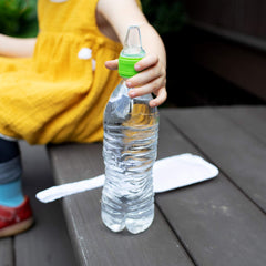 Green Sprouts Spout Adapter in use on a standard bottle for toddler-friendly hydration.