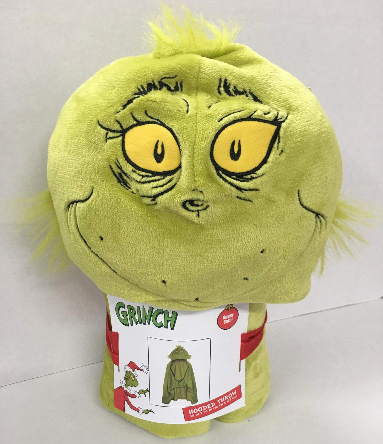 Grinch hooded blanket model snuggling for a relaxed evening.