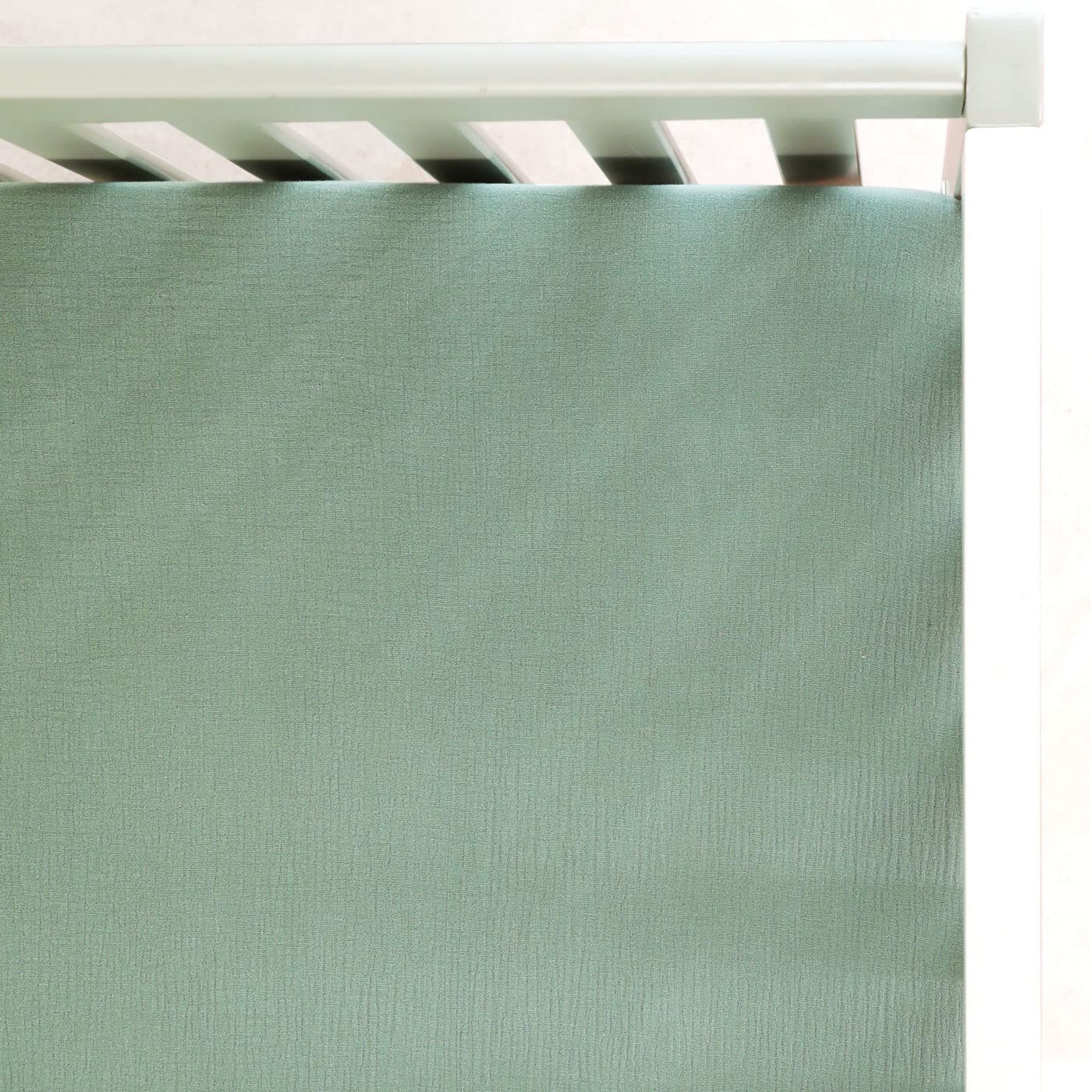 GRSSDER soft muslin crib sheet in Roman Green viewed full on bed for soft, breathable comfort