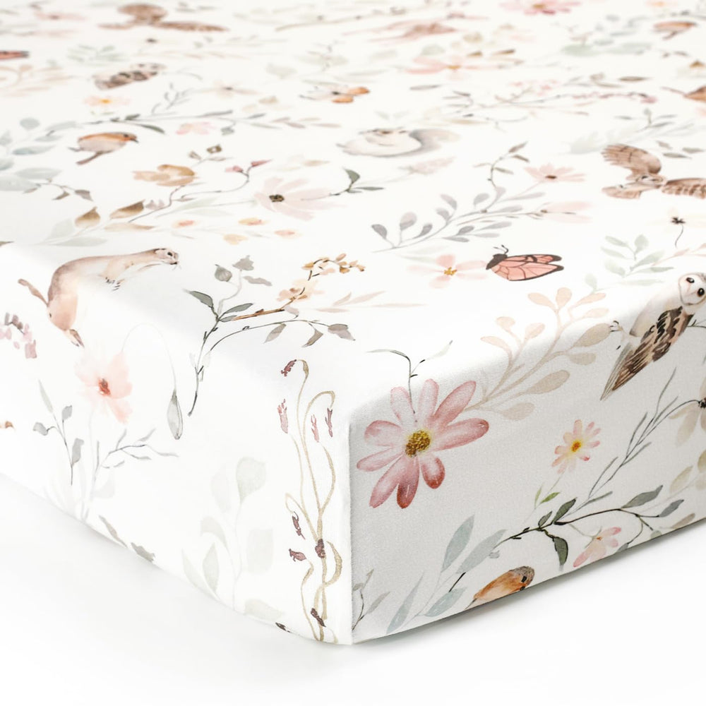 GRSSDER Stretch crib sheet in-use scene shows a cozy, calm nursery setting.