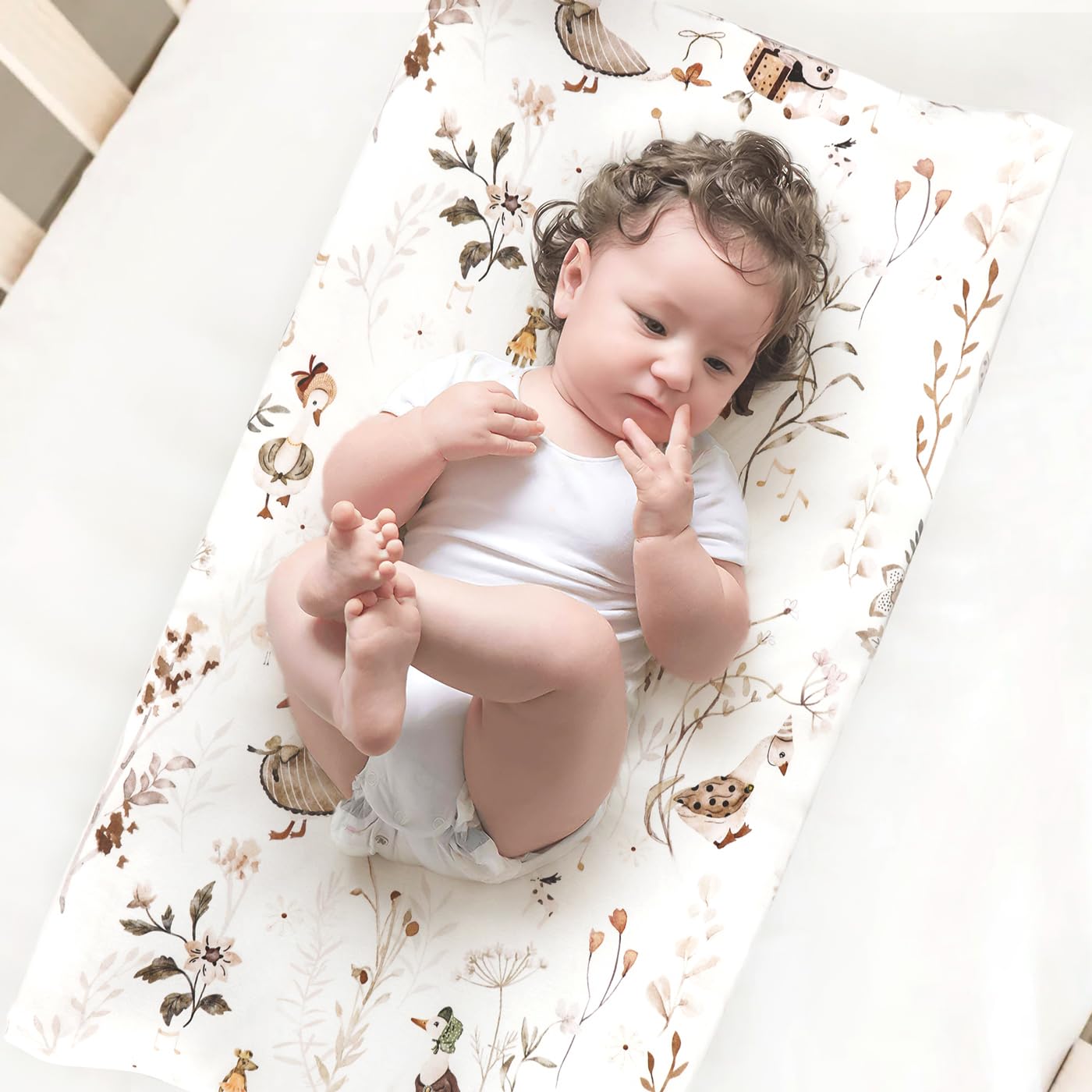GRSSDER cover on changing pad demonstrates 4-way stretch for snug, unrestricted movement