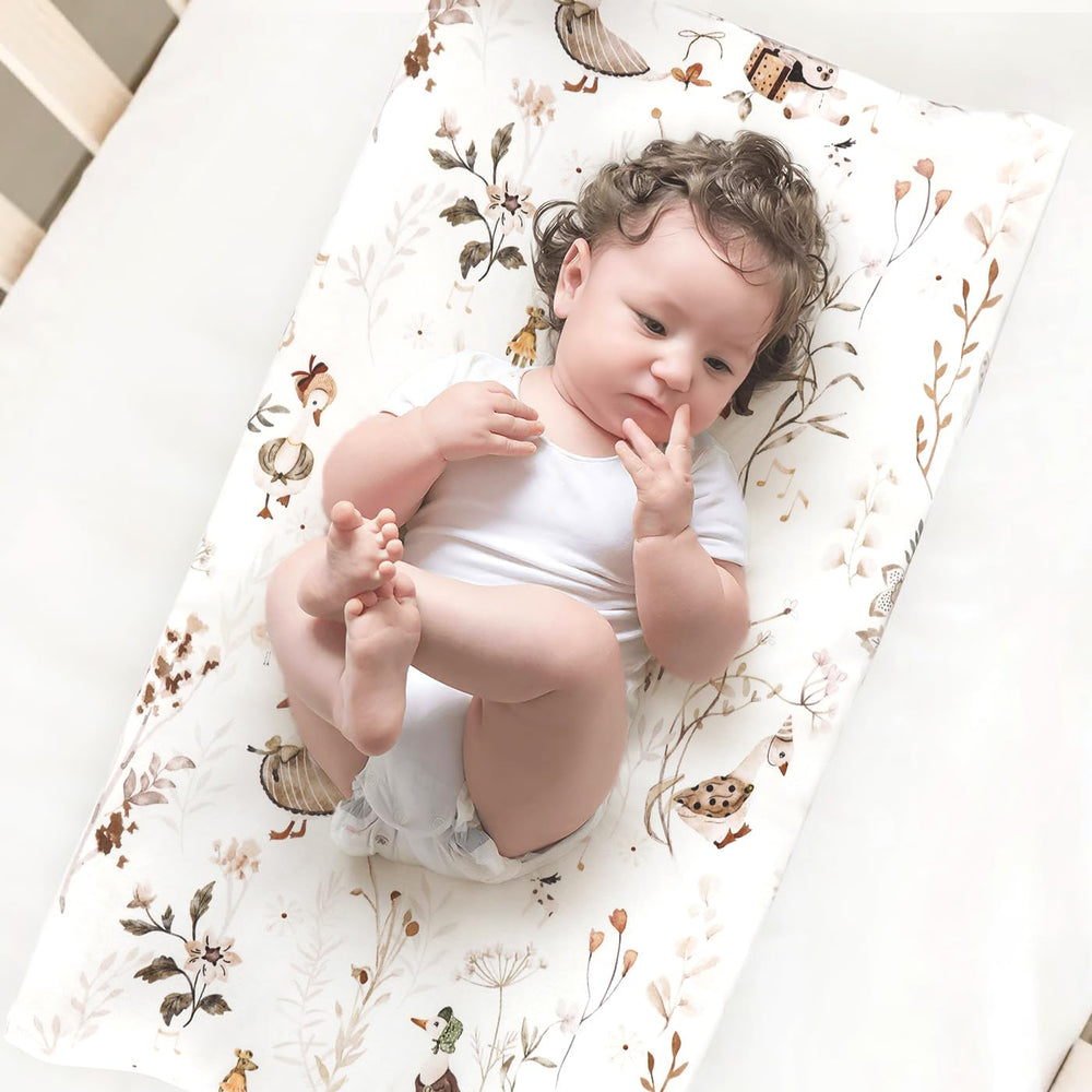 GRSSDER cover on changing pad demonstrates 4-way stretch for snug, unrestricted movement