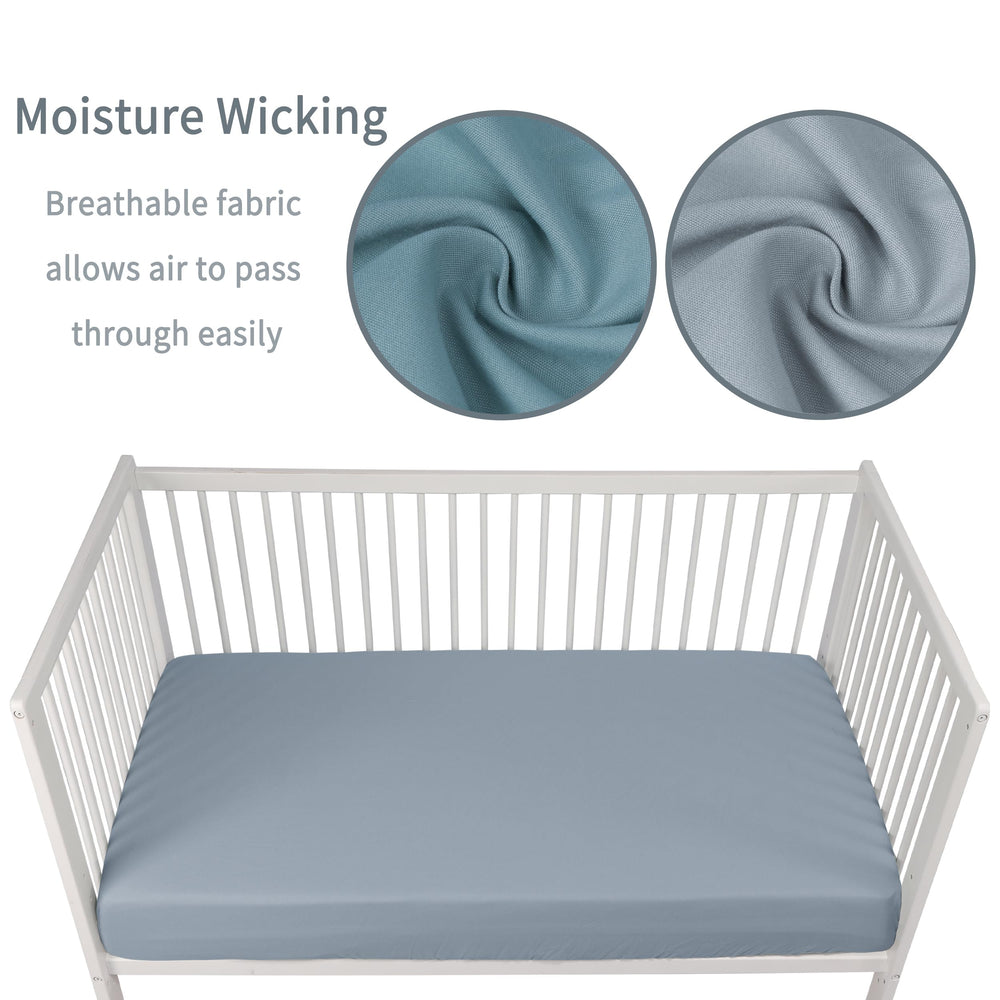 GUNTAIL dark grey crib sheet folded, emphasizing durable, soft fabric.