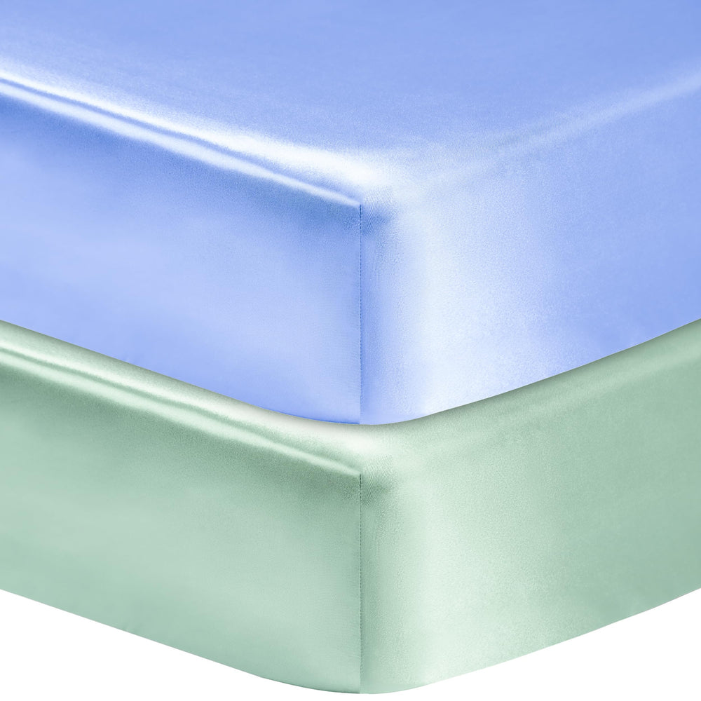 GUNTAIL satin crib sheet blue on mattress offers snug fit and smooth surface for baby comfort